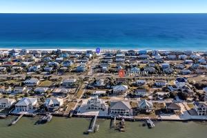 an aerial view of a resort on the beach at Flip Side Oasis Beach House in Pensacola Beach +60 photos