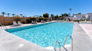 a swimming pool with chairs in a resort at BLUESEA Costa Serena in Torremolinos +32 photos