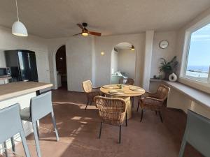 a kitchen and dining room with a table and chairs at local diamond in Guía de Isora