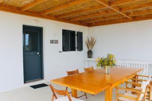 a dining room with a wooden table and chairs at Villa Aria in Kampos Paros