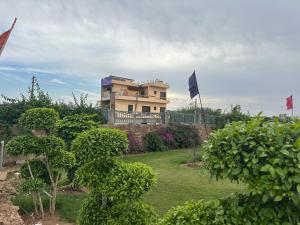 a house with a flag in front of a yard at Army cuisine Dine in and LUXURY NIGHTLY STAY Kurali Punjab in Kūrāli