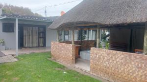 a house with a brick wall in the yard at FRANCHISE BENONI GUEST HOUSE in Benoni