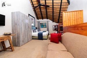a living room with a couch and a bed at INYAMATANE LUXURY LODGES at Kruger Park Lodge in Hazyview +70 photos