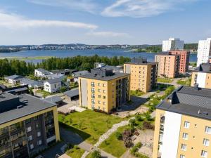 an aerial view of a city with buildings and a river at One More Night in Jyväskylä