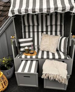 a bench sitting under an awning on a patio at Modernes Apartment in Haiger Allendorf in Haiger