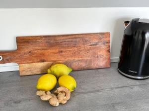 a pile of lemons and mushrooms next to a coffee maker at Modernes Apartment in Haiger Allendorf in Haiger