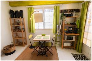a room with a table and a window with green curtains at La Joliette in Junas +58 photos