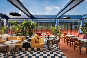 a patio with tables and couches and chairs at Andaz Lisbon, By Hyatt in Lisbon