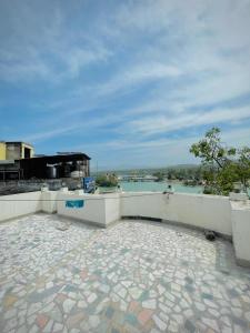 a patio with a view of a body of water at Hotel Har Ki Pauri with terrace Ganga view in Haridwār