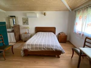 a bedroom with a bed and a table and chairs at Chambre Lucioles in Orniac +2 photos