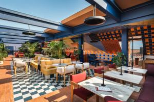 a restaurant with tables and chairs on a checkered floor at Andaz Lisbon, By Hyatt in Lisbon