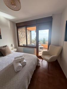 a bedroom with a bed and a chair and a window at Atempo Berzosa Arce in Berzosa del Lozoya