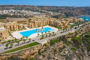 an aerial view of a resort with a pool and buildings at Fort Chambray Island Views in Għajnsielem