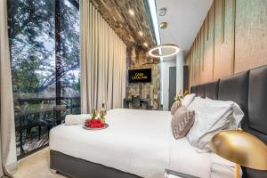 a bedroom with a large bed and a large window at Ultimate 9BR Lleras Villa W Heated Pool in Medellín