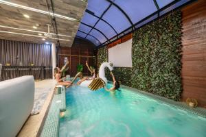 a group of people in a swimming pool at Ultimate 9BR Lleras Villa W Heated Pool in Medellín +19 photos
