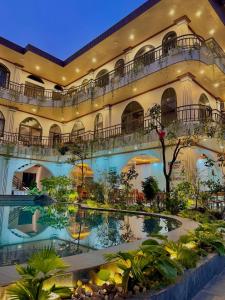 a large building with a pool in front of it at Tuan Ngoc Hotel in Ninh Binh
