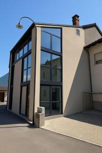a building with large windows and a street light at Tibetan BB in Bellinzona