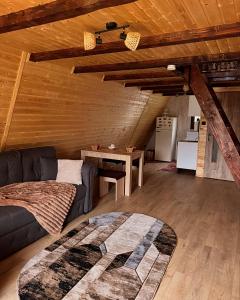 a living room with a couch and a table at Căsuțele EliMar in Chirleşti