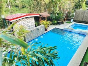 a swimming pool in the middle of a yard at Soulelle Villa in Silang