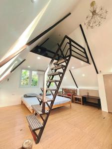 a bedroom with a bunk bed and a ladder at Soulelle Villa in Silang