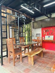 a table and chairs and a table and a bench at Soulelle Villa in Silang