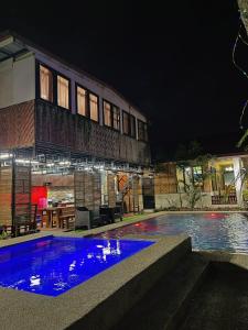 a swimming pool in front of a building at night at Soulelle Villa in Silang +37 photos