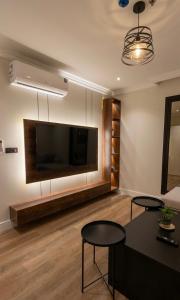 a living room with a large flat screen tv at نسمة الخبر كورنيش اقامة رائعة وهادئة in Dammam