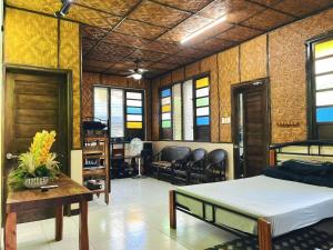 a room with a bed and a table and chairs at Soulelle Villa in Silang