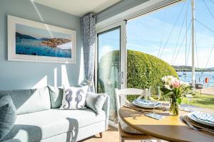 a living room with a couch and a table at No 5 The Salcombe in Salcombe +58 photos