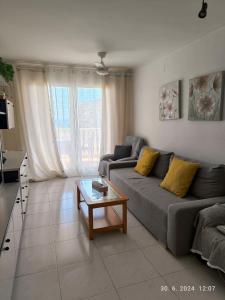 a living room with a couch and a coffee table at Sea View Apartman Daimus in Daimuz