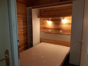 a small room with a bench in a room with wooden walls at Chalet in Marcilly-sur-Eure