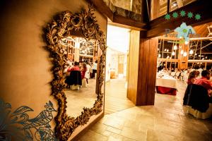 a mirror hanging on a wall in a restaurant at Hotel Ruralis Peña Del Alba in Arroyomolinos de la Vera +50 photos