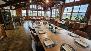 a man sitting at a table in a restaurant at Hotel Oskar Zaplata in Preddvor
