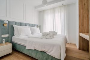 a bedroom with a bed with towels on it at Adria Concept Suites in Zadar +188 photos