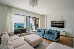 a living room with a couch and two chairs at Adria Concept Suites in Zadar