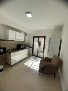 a living room with a couch and a kitchen at La Buena Memoria in San Juan