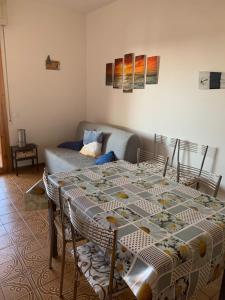 a living room with a table and a couch at Casa Selia in Cecina