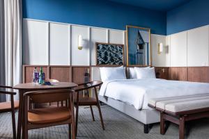 a hotel room with a bed and a table at Radisson BLU Hotel Nantes in Nantes +51 photos
