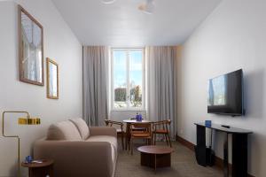 a living room with a couch and a table at Radisson BLU Hotel Nantes in Nantes