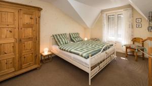 a bedroom with a bed and a wooden cabinet at Villa Robert Heuser in Traben-Trarbach