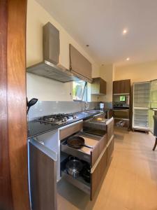 a large kitchen with a stove top oven at Mandharini UNIT 35 in Kilifi +9 photos