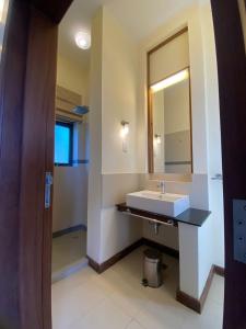 a bathroom with a sink and a mirror at Mandharini UNIT 35 in Kilifi