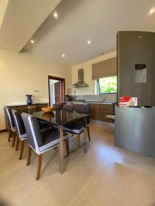 a kitchen and dining room with a table and chairs at Mandharini UNIT 35 in Kilifi