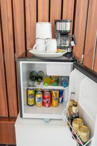 an open refrigerator filled with lots of drinks at Mansion Altamirano Hotel in San Antonio