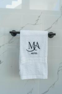a towel on a table with a hotel sign on it at Mansion Altamirano Hotel in San Antonio