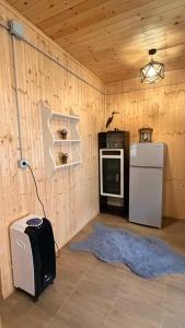 a room with a kitchen with a refrigerator and a stove at Shpija Ujevara e Vogel 2 in Theth