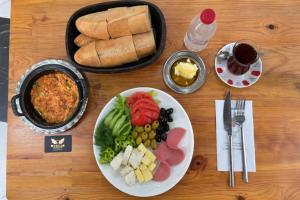 a table with a plate of food and a plate of bread at ERSA Hotel in Tuzla