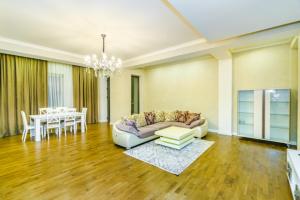 a living room with a couch and a table at Luxury Home VIP Chaila Tower in Baku