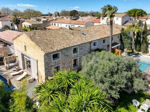 an aerial view of a house with a swimming pool at La Pause Camarguaise in Saint-Laurent-dʼAigouze