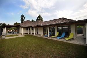 a group of chairs sitting on a patio at Laura Villa in Balatonlelle